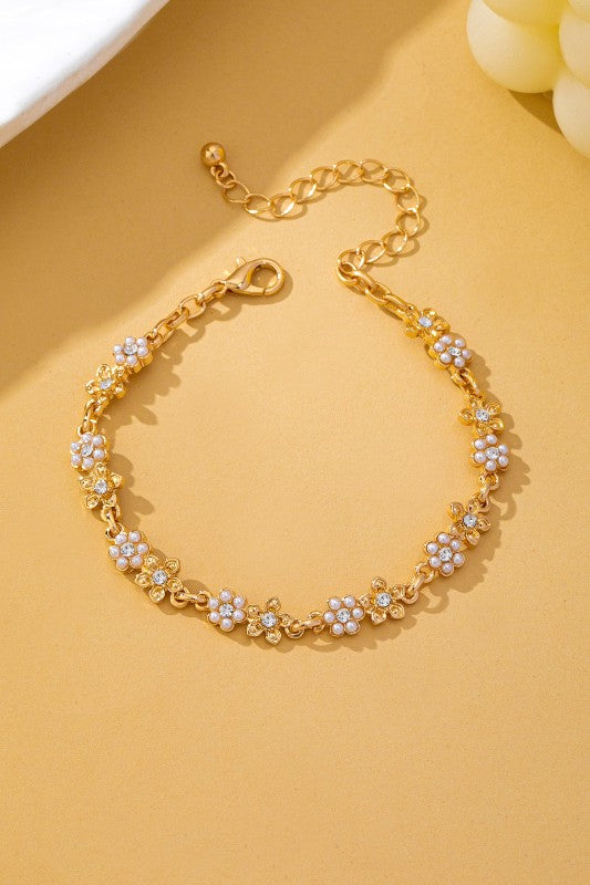Pulsera dorada de flores con perlas y brillantes
